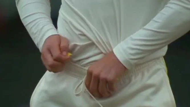 Cameron Bancroft is seen hiding a yellow piece of sandpaper down his trousers