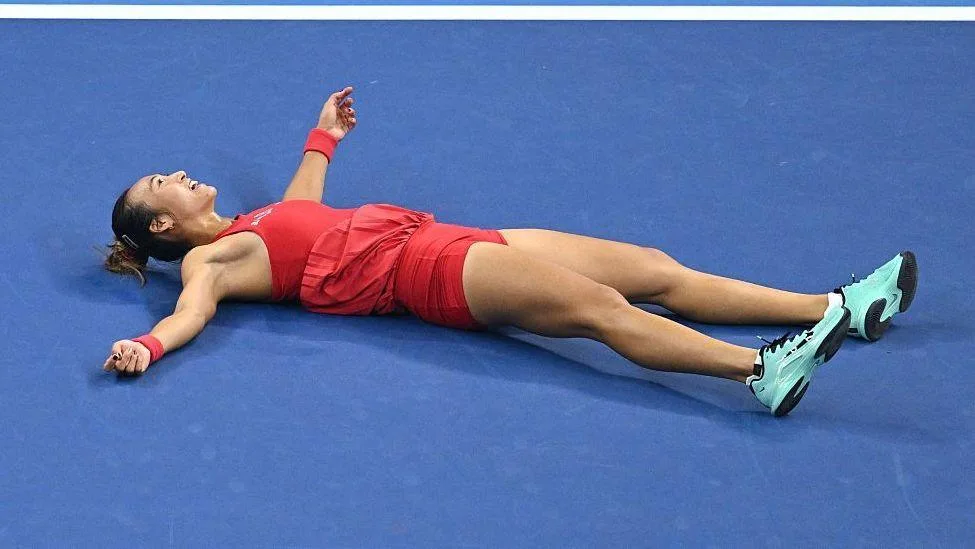 Zheng Qinwen collapses on the court in celebration