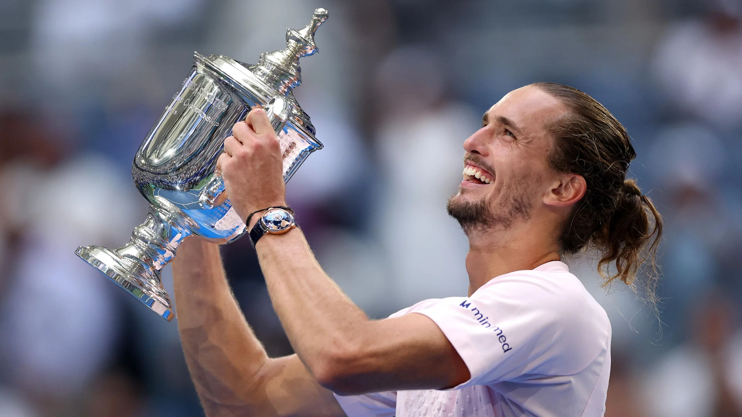 Alexander Zverev celebrates with the US Open trophy
