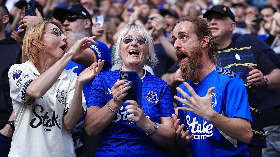 Three Everton fans enjoying a match