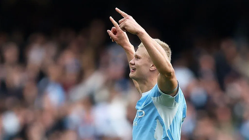 Erling Haaland celebrates scoring a Premier League goal for Manchester City by raising his arms aloft at the Etihad Stadium