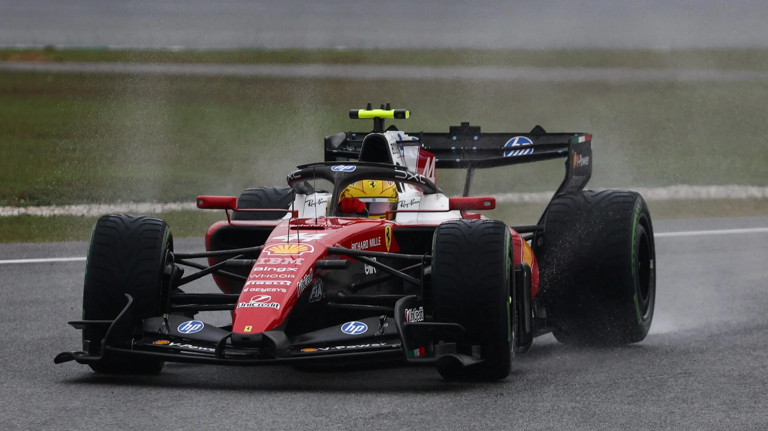 Ferrari's Lewis Hamilton throws up spray during the aborted formation laps at the Bahrian Grand Prix in Malaysia
