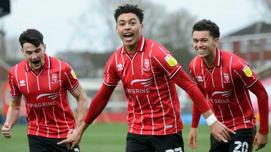 Morgan Rogers celebrating scoring for Lincoln City with Brennan Johnson in the background