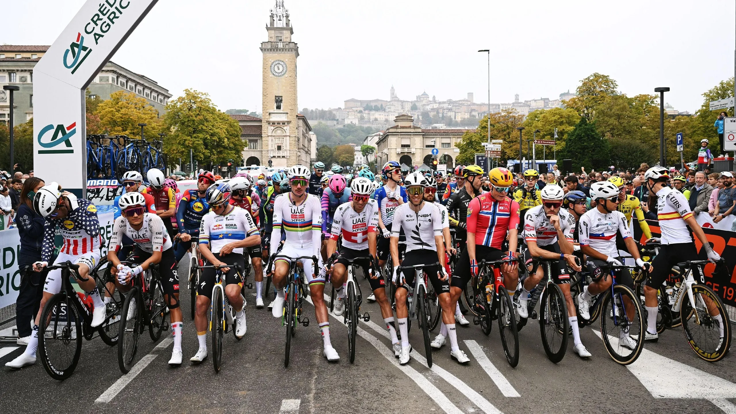 Riders at the Giro di Lombardia stage a protest prior to the start of the race