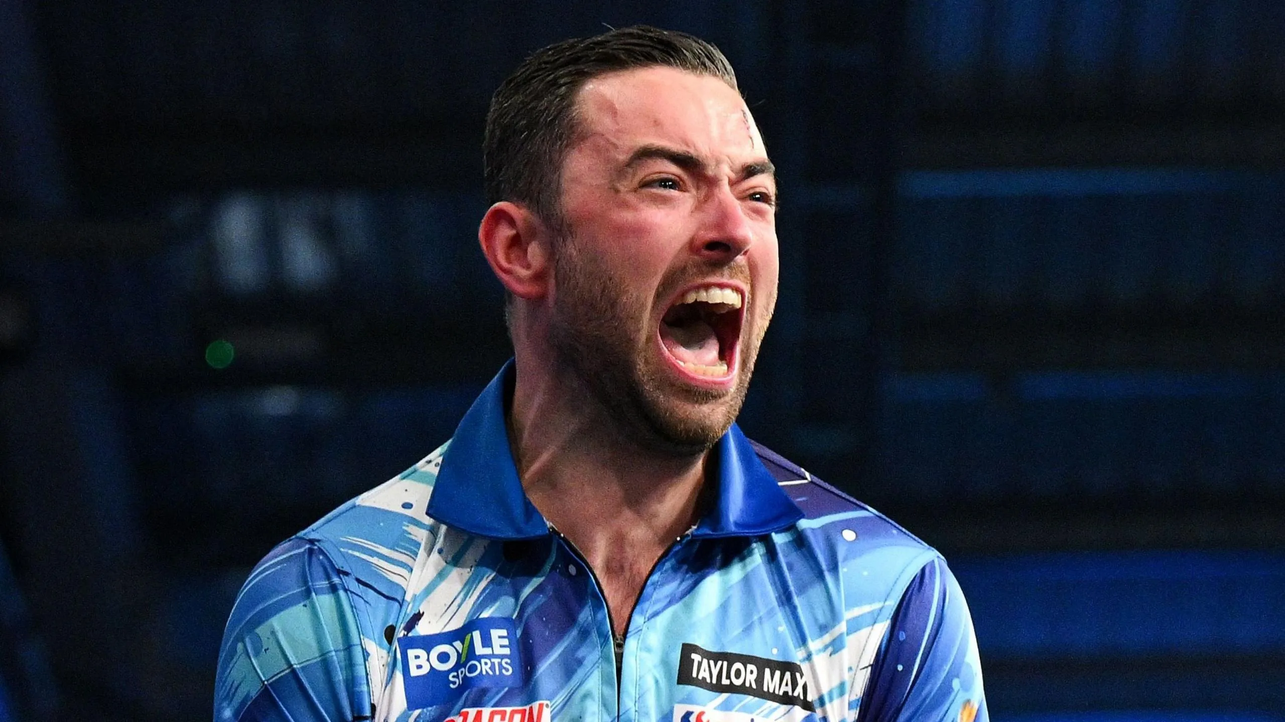 Luke Humphries celebrates beating Gerwyn Price to win the World Grand Prix