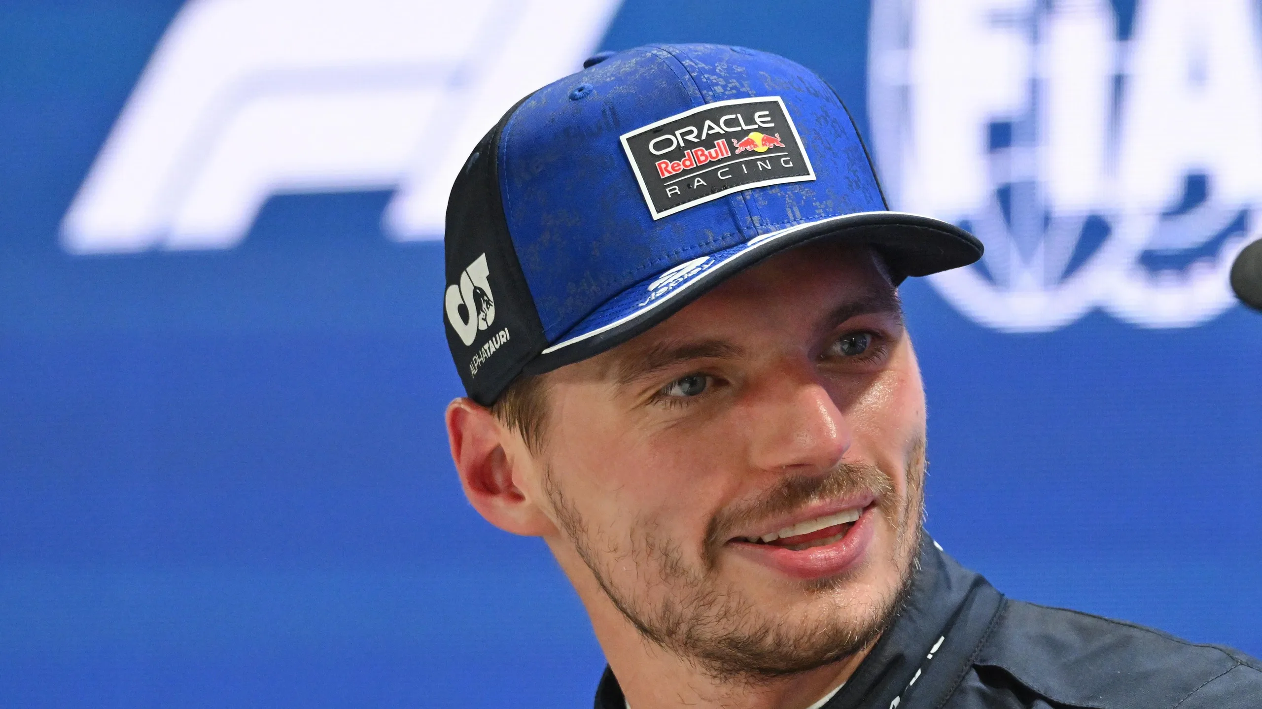 Max Verstappen smiling after taking pole position for the Singapore Grand Prix