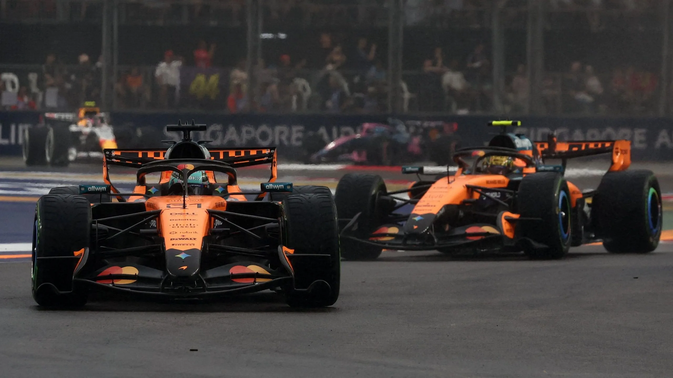 McLaren's Oscar Piastri with team-mate Lando Norris following behind during the Singapore Grand Prix sprint race