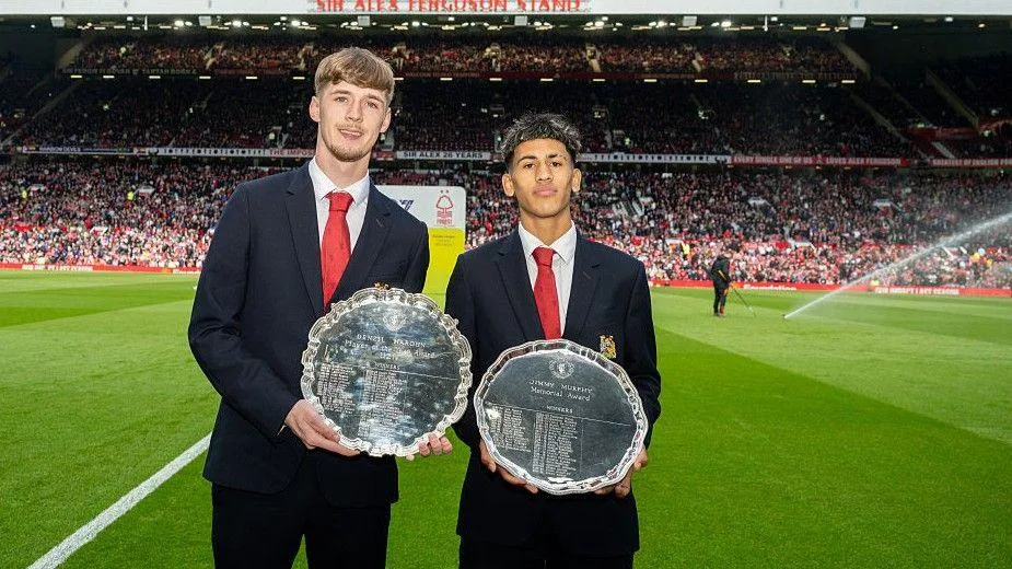 JJ Gabriel (right) collects his Manchester United Under-18 player of the year award at Old Trafford in May
