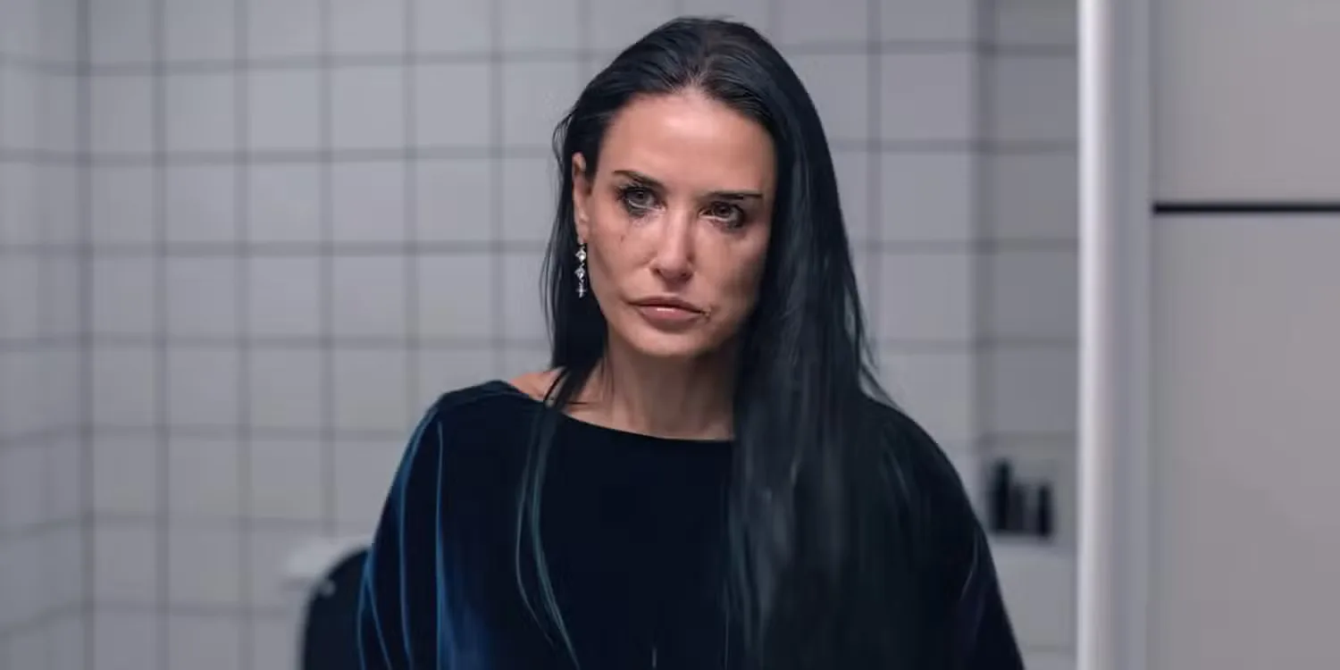 Demi Moore looking in the mirror while cray in in The Substance