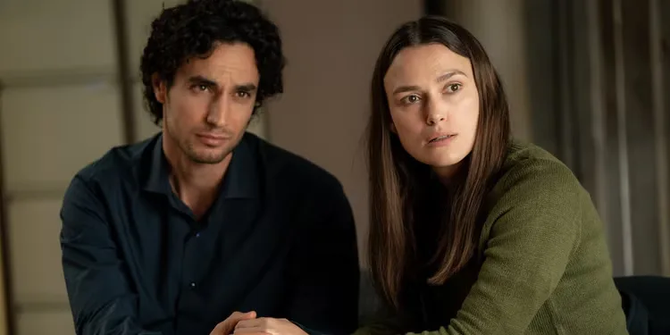 Keira Knightley and Adam Bakri holding hands in Official Secrets