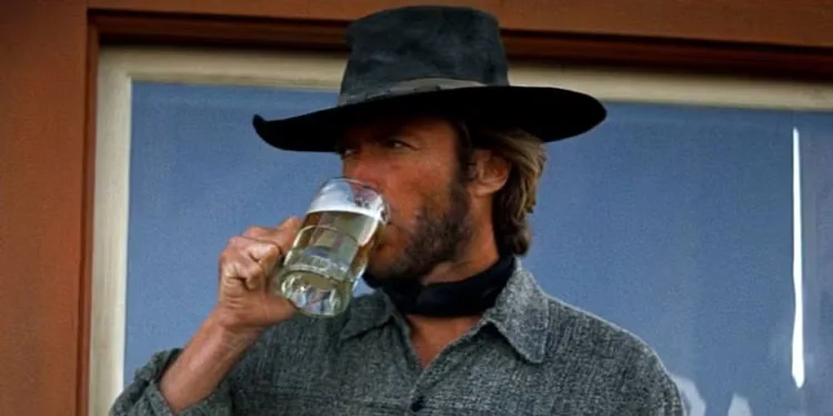 Clint Eastwood as The Stranger having a drink in High Plains Drifter.