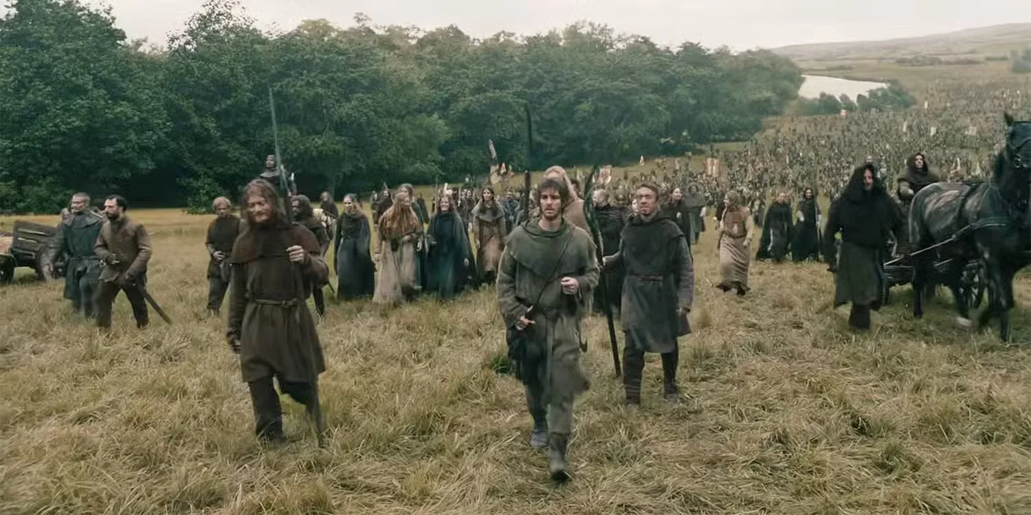 The Ploughman (Andrew Garfield) leading thousands of peasants across a field in 'The Uprising'