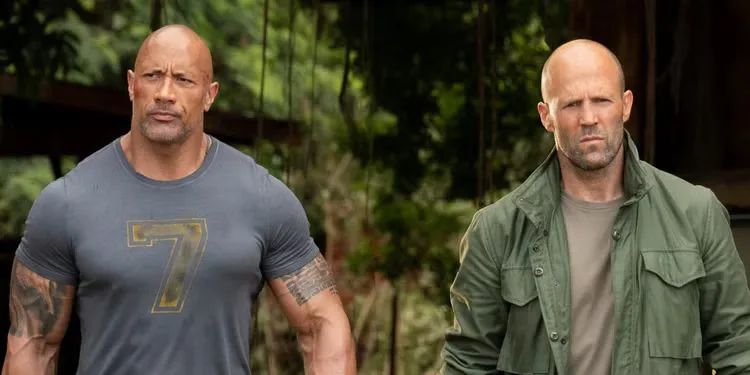 Dwayne Johnson and Jason Statham walk through a jungle in 'Hobbs & Shaw'