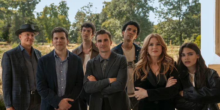 The cast of Now You See Me: Now You Don't stand in a doorway looking expectant.
