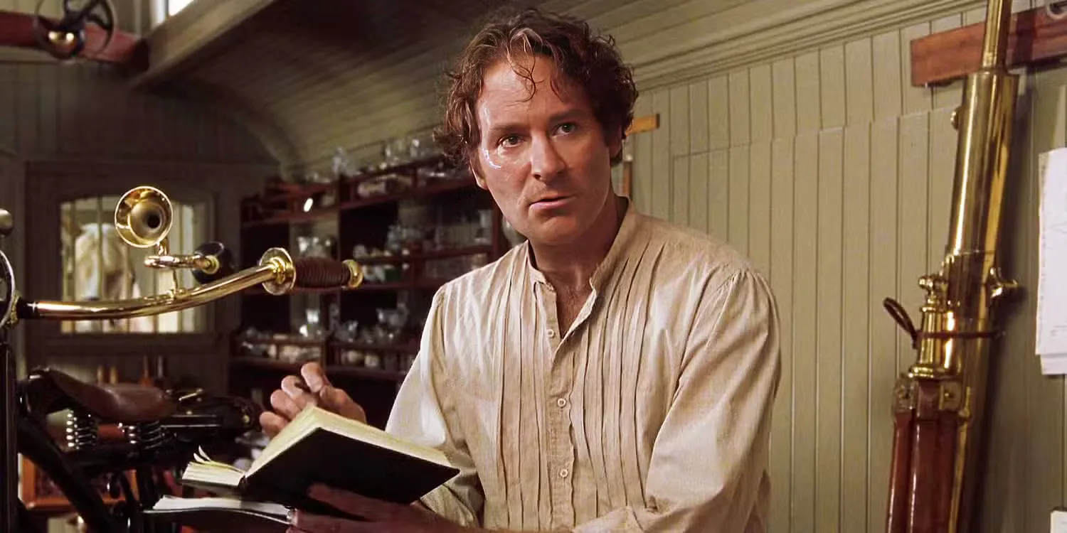 Kevin Kline in a white shirt flicking through a book in 'Wild Wild West'