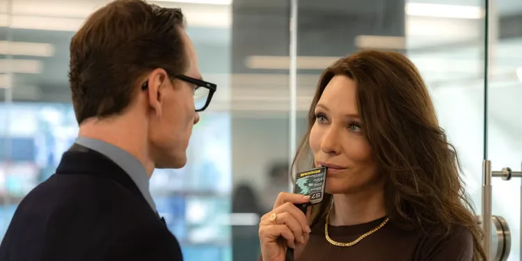 Cate Blanchett with a badge by her mouth makes eyes at Michael Fassbender in 'Black Bag' (2025)