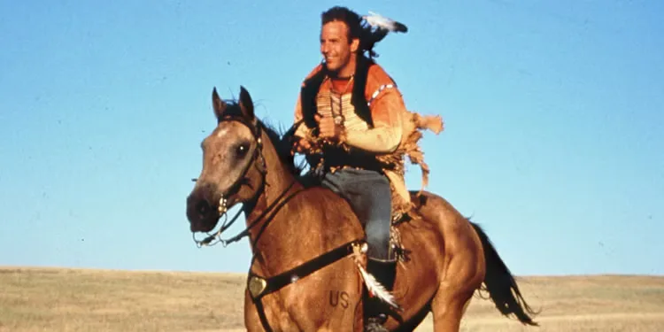 Kevin Costner as Lt. John J. Dunbar, riding a horse and smiling in Dances with Wolves