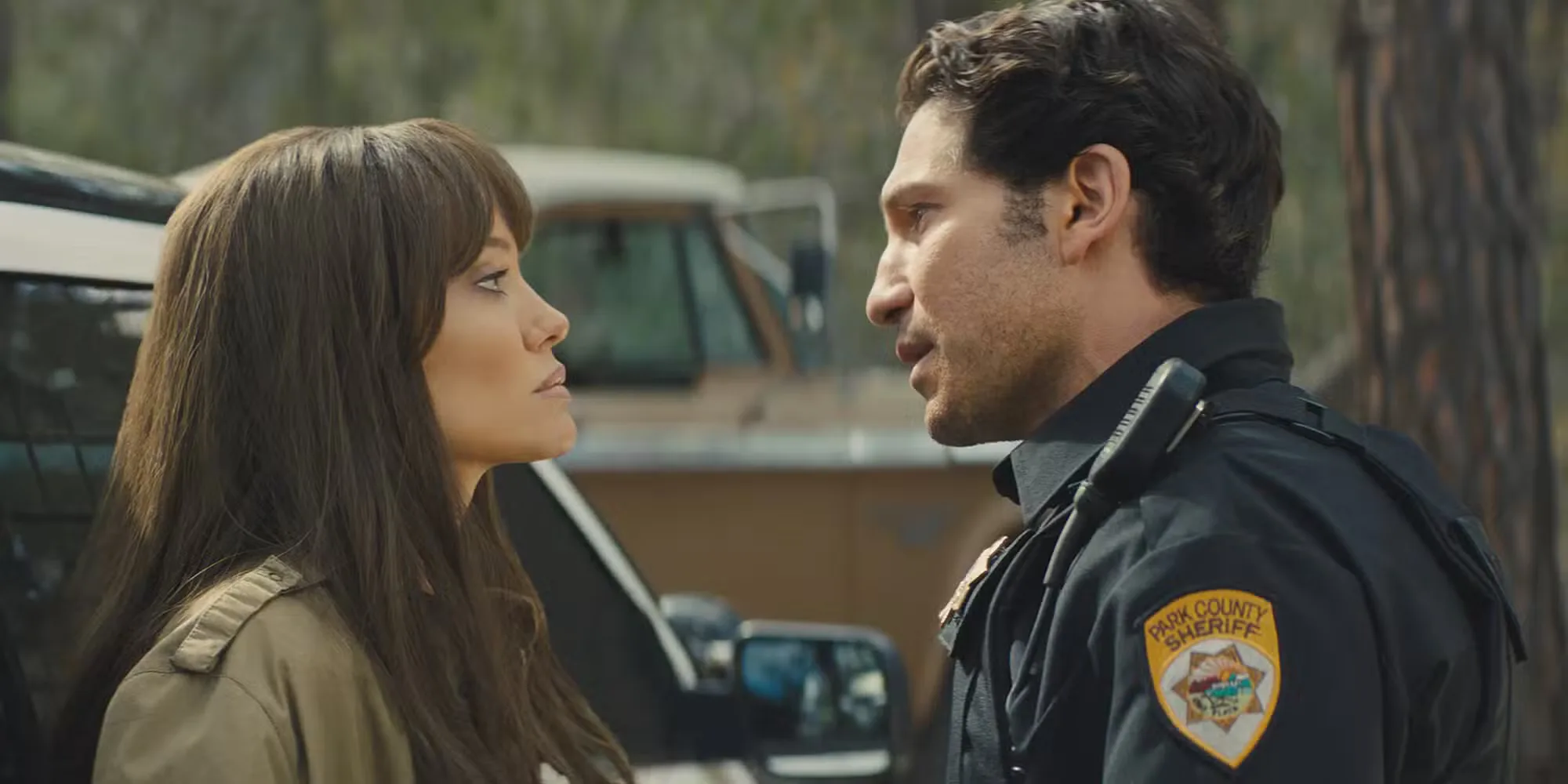 Hannah and Ethan looking at each other while standing really close in Those Who Wish Me Dead