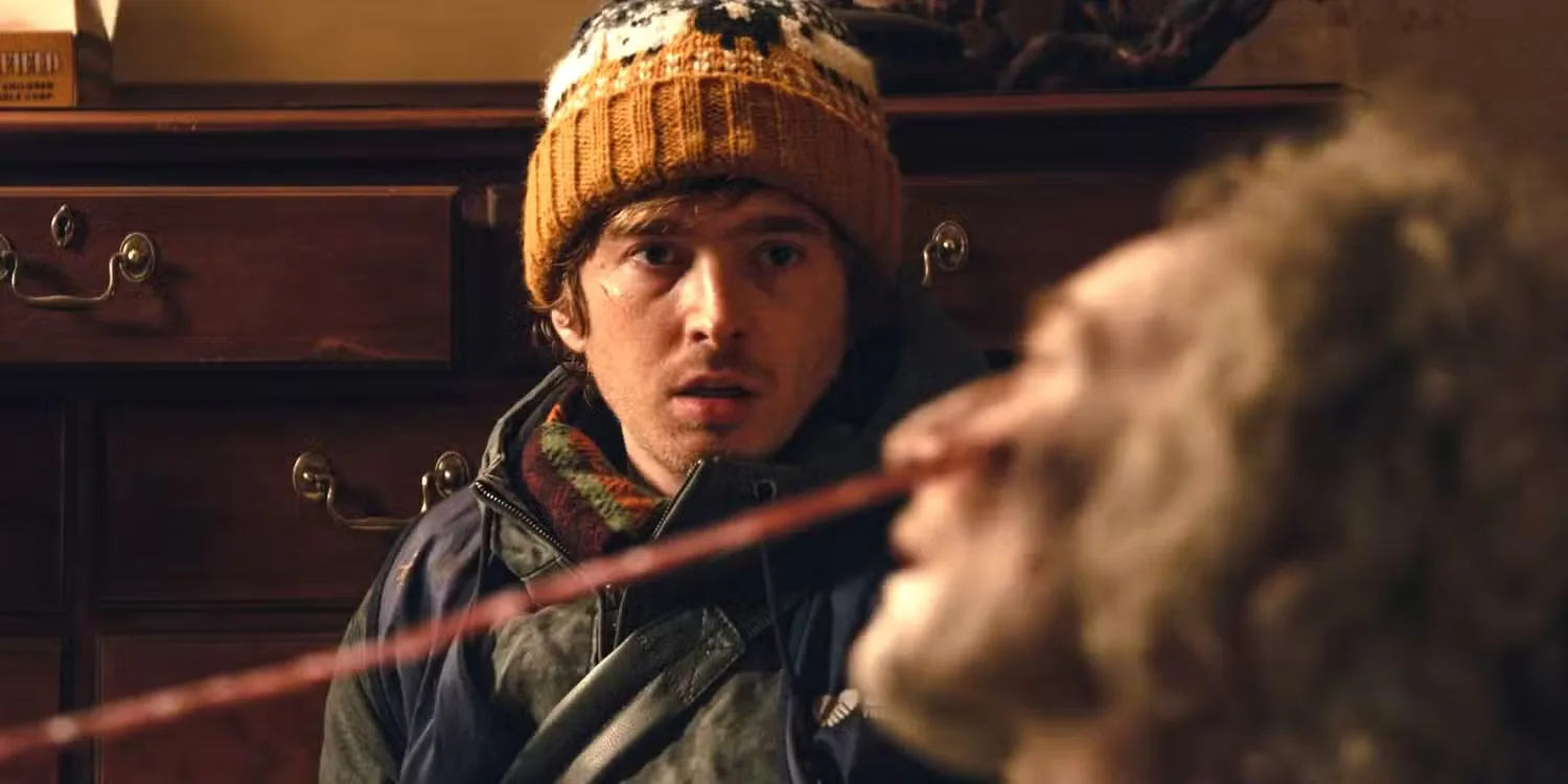 Austin Abrams as Bryan staring at an infected person in Resident Evil.