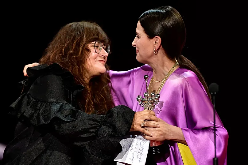 FILE: French actress Juliette Binoche (right) receives the Donostia Award from Coixet (left) for her contribution to cinema at the 70th San Sebastián Film Festival, 2022