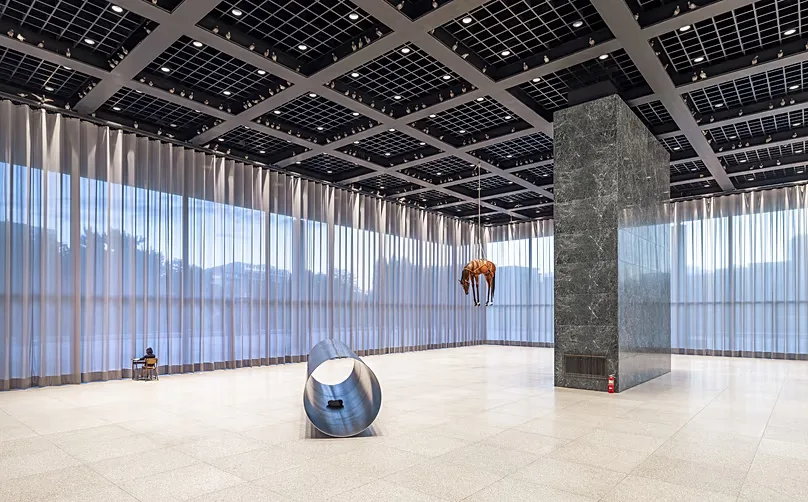 Cattelan’s Novecento features a horse hanging from the ceiling, symbolising the exhaustion and collapse of power.