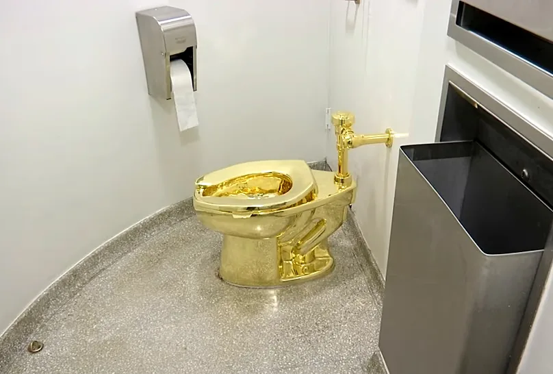 Cattelan’s America, an 18-carat gold toilet, was created as a satire of excessive wealth.