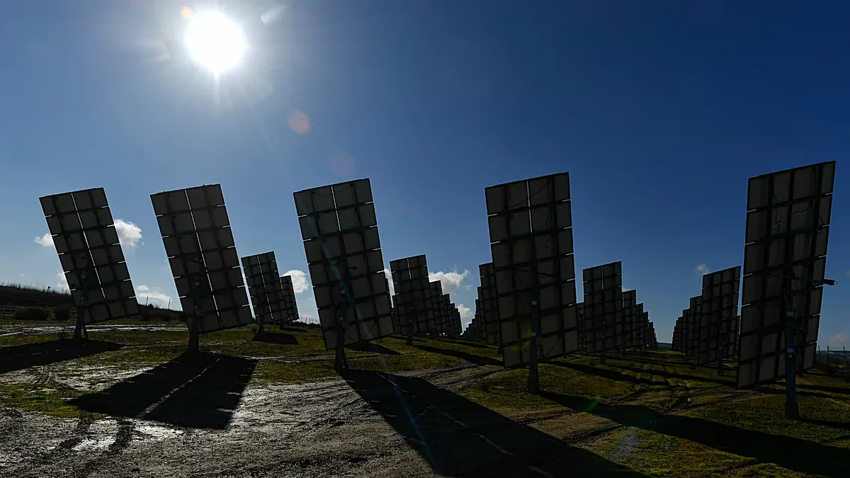 Solar panels work in Los Arcos, Navarra Province, northern Spain, Friday, Feb. 24, 2023