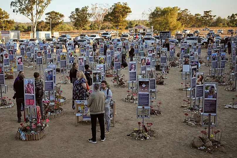 Photographs of the victims of the Hamas attacks have been erected at the site of the Nova Music festival as families gathered to mourn. 7 October, 2026.