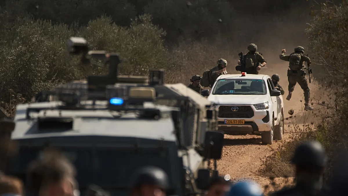 Members of Israeli forces arrive at a blocked road preventing Palestinians from reaching groves to harvest olives in the West Bank town of Turmus Ayya, Wednesday, Oct. 21.