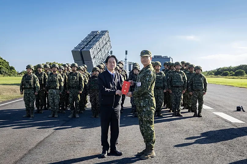 Taiwan's President William Lai Ching-te poses for photos with soldiers during an inspection of a missile base in Pingtung county in southern Taiwan on Friday, Sep. 18, 2026