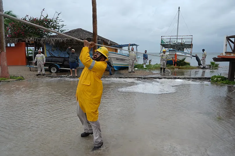 Workers pull a boat to shore as Hurricane Polo approaches Puerto San Carlos, 28 September, 2026