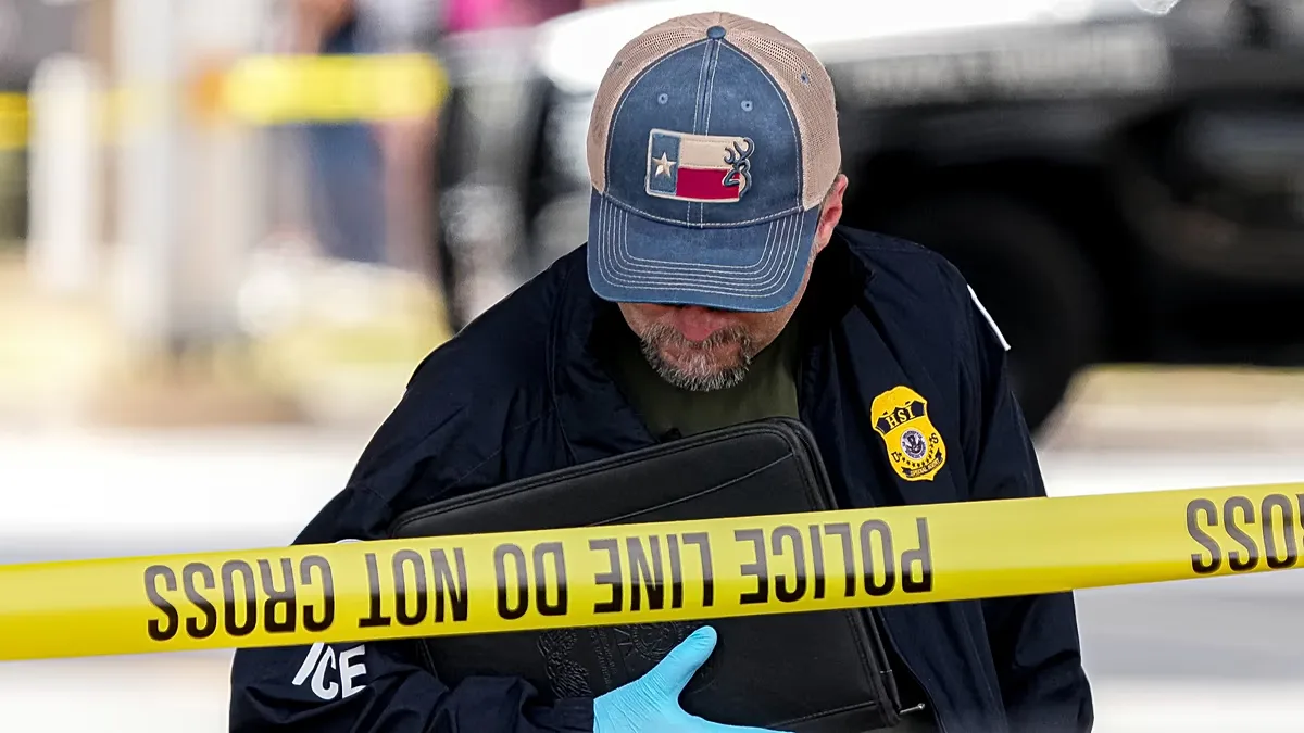 Immigration and Customs Enforcement officers stand at the scene where a man was shot in his vehicle by an ICE officer, in Austin, Texas. 21 September 2026