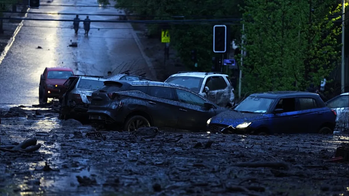 Vehicles are partially inundated in muddy floodwaters after heavy rains caused flash flooding in the Las Condes district of Santiago, Chile, Thursday, Oct. 8, 2026