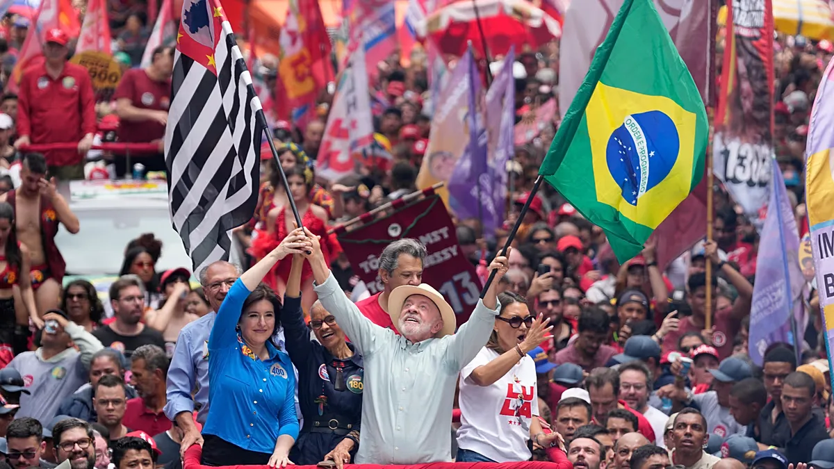President Luiz Inácio Lula da Silva, who is standing for re-election, waves the flags of Brazil and the state of São Paulo at a campaign rally