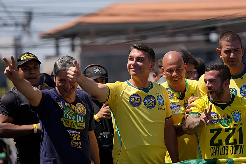Opposition presidential candidate Senator Flavio Bolsonaro, centre, gives a 'thumbs up' sign to supporters during a campaign rally