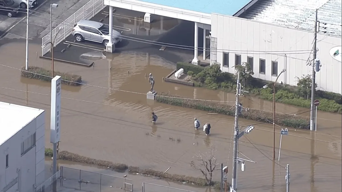 People wade through hip-deep floods a day after Typhoon Dujuan made landfall in Japan, triggering landslides, torrential rains, major floods, Chiba, Japan, 22 September, 2026