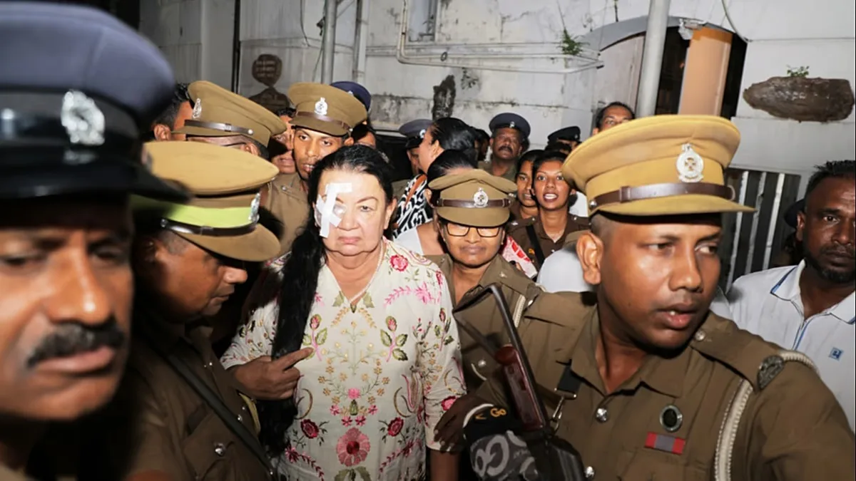 Prison officers escort Shiranthi Rajapaksa, wife of Sri Lanka's former President Mahinda Rajapaksa, to a prison vehicle outside a court in Colombo, Wednesday, Oct. 7, 2026