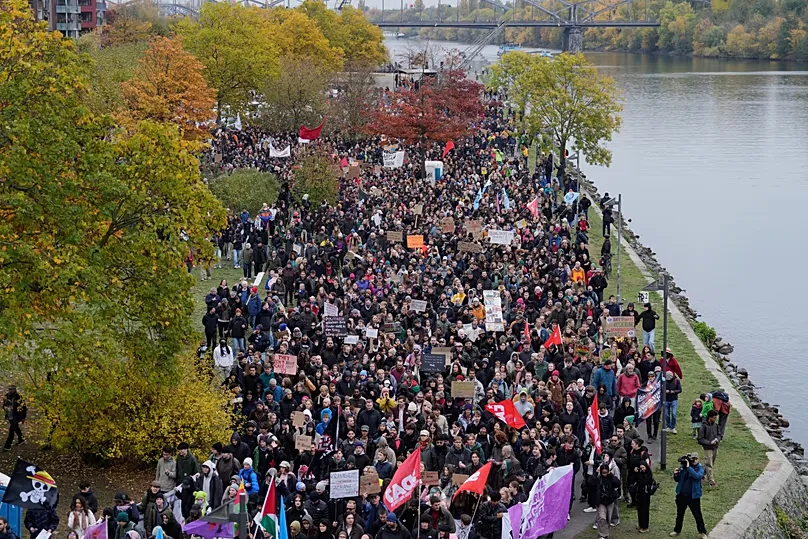 Demonstrators gather at the banks of the river. Main for a protest under the slogan "Gen Z Takes Care of It" in Frankfurt, Germany, Saturday, Oct. 31, 2026.