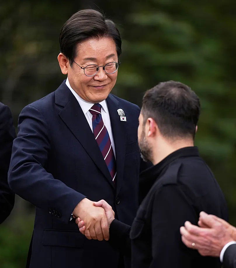 South Korean President Lee Jae-myung shakes hands with Ukraine's President Zelenskyy after posing for photos at the G7 Summit in Alberta, Canada, Tuesday, June 17, 2025
