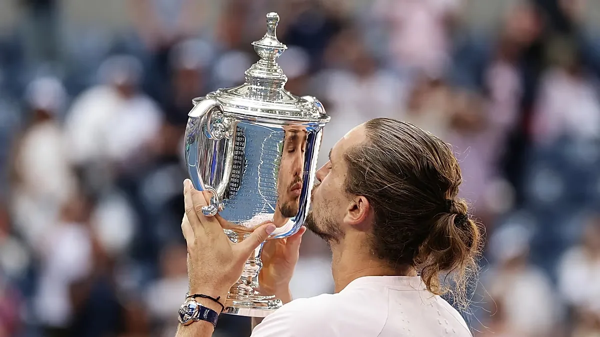 Alexander Zverev, of Germany, goes to kiss the trophy after he won the men's singles final of the U.S. Open tennis championships against Ben Shelton, of the United States