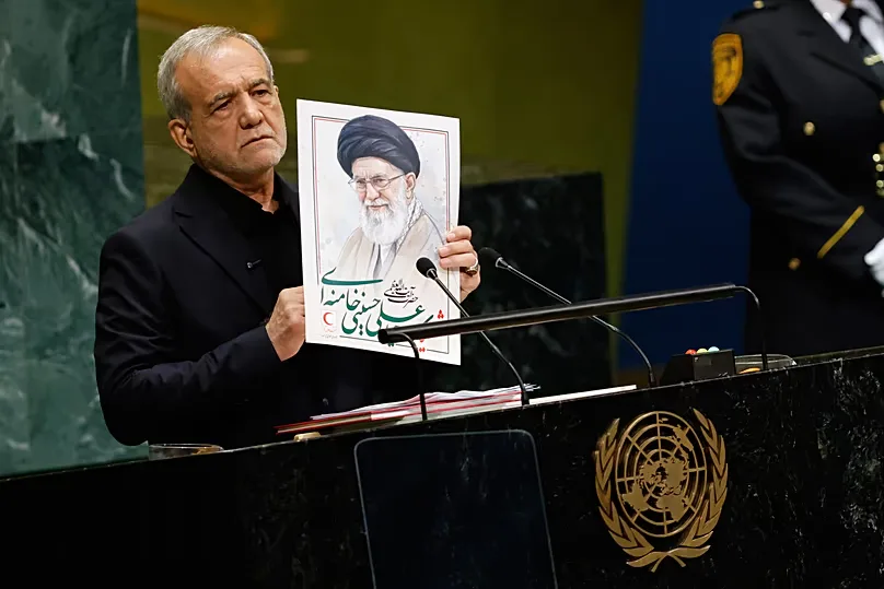 Pezeshkian holds an image of late Iranian Supreme Leader Ayatollah Ali Khamenei during the 81st session of the United Nations General Assembly at United Nations headquarters.