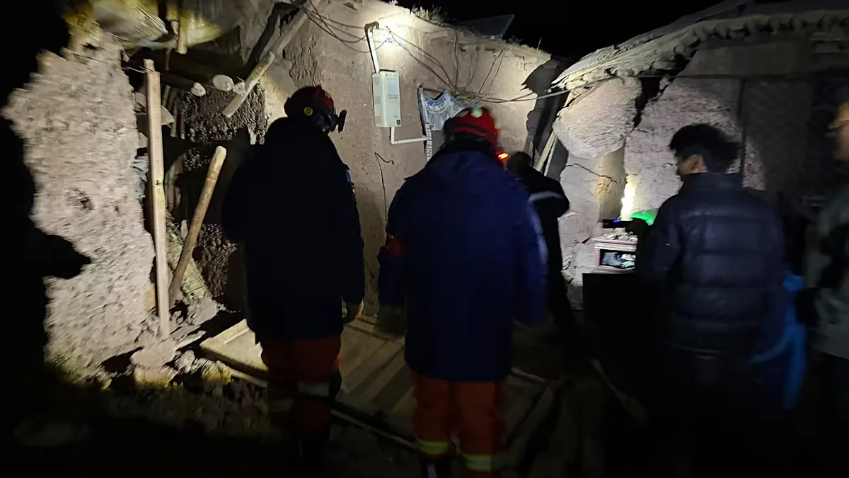 In this photo released by Xinhua News Agency, firefighters inspect an earthquake-hit village houses in Baqen County of Nagqu City in China's Tibet autonomous region.